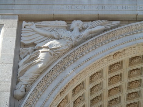 Fame, sounding her trumpet, float inside one of the extrados of the Washington Square Arch.